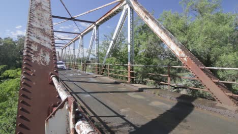 EDITORIAL-PELOTON-of-CYCLISTS-Crossing-a-Single-Lane-Bridge