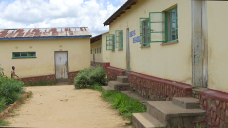 Old-School-Buildings-in-Rural-Zimbabwe,-Africa-on-a-Sunny-Day,-Smooth-Steadycam-Forward-Movement