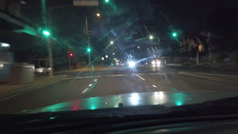 View-through-the-window-of-a-car-as-it-drives-through-the-city-at-night