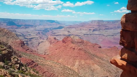 Pullpack-shot-of-young-woman-taking-picture-of-Grand-Canyon-from-Desert-View-Watchtower-in-summer-in-Grand-Canyon-National-Park,-AZ,-United-States