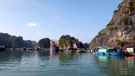 Fishing-boats-on-the-shores-closely-linked-with-fishermen-loading-decks,-Forward-dolly-shot