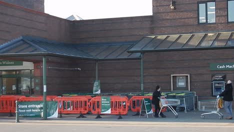 Corona-virus-public-safe-distance-queue-outside-supermarket-barricade