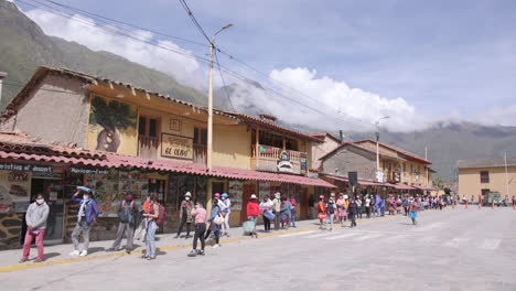 A-group-of-women-lined-up-6-feet-apart-in-Plaza-de-Armas-to-enter-the-market-during-the-pandemic-in-Ollantaytambo,-Peru