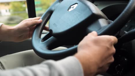 Primer-Plano-En-Las-Manos-De-Un-Hombre-Blanco-Conduciendo-Un-Volante-De-Furgoneta-Renault