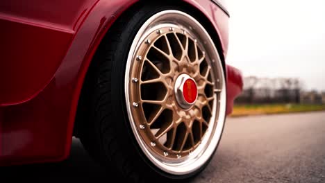 Gold-BBS-back-wheel-on-driving-VW-Volkswagen-Golf-MK1-car,-close-up