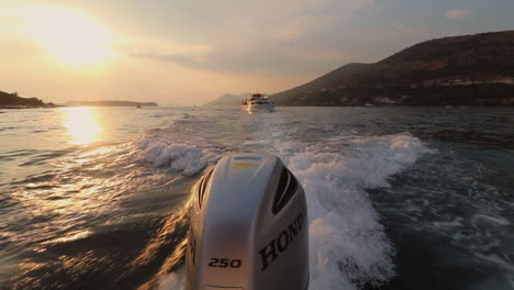 Beautiful-sunset-shot-from-a-running-boat-and-a-bigger-yacht-on-background