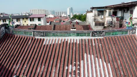 Reveal-shot-of-Kew-Leong-Tong-Lim-Kongsi-clan-temple-in-Lebuh-street,-Aerial-drone-fly-out-shot