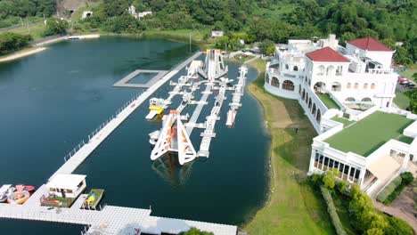 People-enjoying-a-sunny-day-at-Hong-Kong-core-aqua-park-floating-fun-slides,-Aerial-view