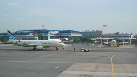 Pushback-Tug-And-Airplane-Of-Air-Busan-At-The-Tarmac-Of-Gimhae-International-Airport-In-Busan-On-A-Sunny-Day