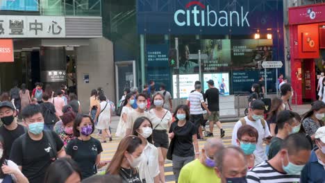 A-crowd-of-pedestrians-is-seen-walking-across-the-road-through-a-zebra-crossing-in-Hong-Kong