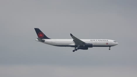 Tracking-shot-of-Air-Canada-passenger-airplane-flying-through-a-clear-sky-during-the-day-at-Toronto-International-Airport