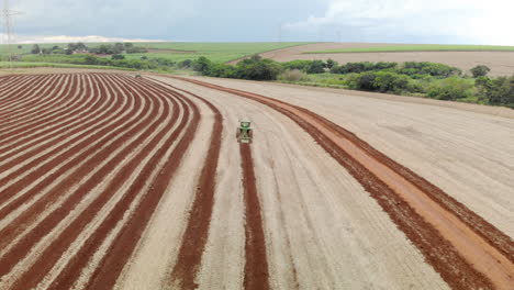 Tractor-plowing-the-land,-preparing-the-soil-for-planting