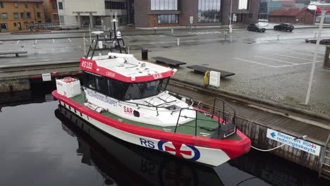 Closeup-of-SAR-rescue-vessel-Sjomann-from-Redningsselskapet-company-in-Stavanger-Norway---Closeup-aerial-moving-slowly-backwards-over-water