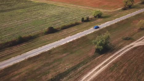 Vista-Aérea-De-Un-Puma-Ford-Azul-Acelerando-En-Una-Carretera-Rural