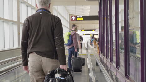 People-with-suitcases-approach-departure-gates,-at-Seattle-Tacoma-International-Airport