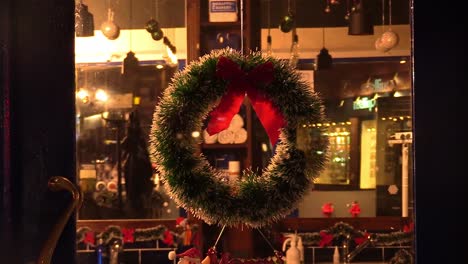 Still-viodoe-shot-of-closed-barbershop-in-Ireland-at-Chrismas-time-with-reflections-of-people-in-the-window