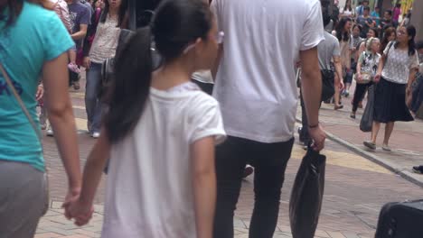 Slow-motion-first-person-view-of-a-crowd-of-chinese-people-walking-the-road-in-Hong-Kong