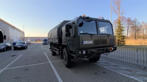 Tracking-motion-jelzc-star,-Polish-military-truck-at-Ukrainian-refugee-camp,-Warsaw-Expo