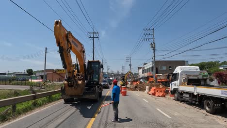 Construction-Worker-Directing-Traffic-On-The-Road-With-Ongoing-Roadworks