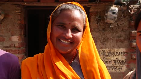 Smiling-Indian-mother-with-son-and-daughter-at-home-in-rural-area-of-Rajasthan