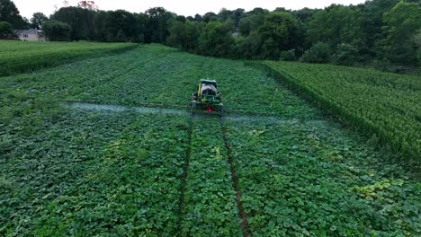 Rising-aerial-shot-from-behind-John-Deere-sprayer