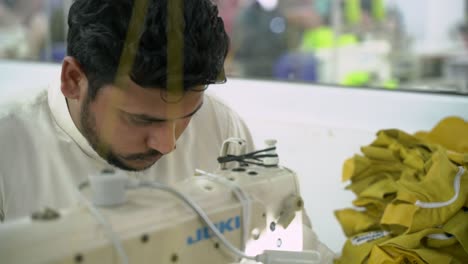 Portrait-Of-A-Man-Sewing-In-A-Clothing-Manufacturing-Plant-In-Pakistan