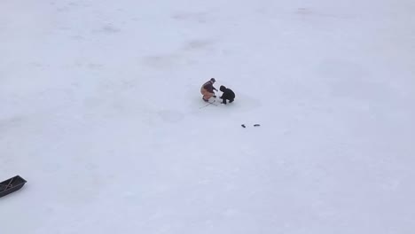 Get-an-aerial-view-of-Ice-Fishing-on-Fitzgerald-Pond,-Maine