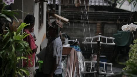 Slow-motion-of-Balinese-family-under-rain-during-monsoon