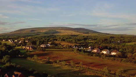 Paso-Aéreo-Sobre-Un-Pueblo-Rural-Irlandés-Cerca-De-Un-Gran-Lago