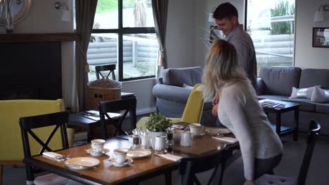 SLOWMO---Young-attractive-couple-sitting-down-at-table-in-boutique-hotel-to-have-breakfast