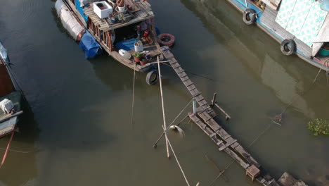 Drone-shot-flying-over-traditional-Vietnamese-Riverboats-of-Ho-Chi-Minh-City-in-late-afternoon