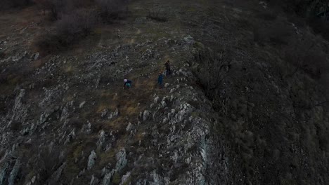 Children-play-on-edge-of-cliff---aerial-tracking-shot