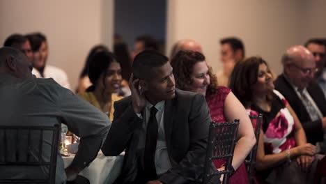 Crowd-laughing-during-a-speech-at-a-wedding-reception