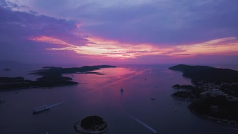 Aerial-view,-flying-low-to-reveal-ships-and-islands