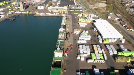 Aerial-view-of-three-ships-being-loaded-in-industry-harbour