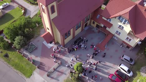 Aerial-shot-of-a-wedding-ceremony-in-a-small-church-on-a-coutryside