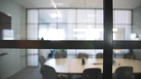 Close-up-dolly-of-windows-showing-meeting-room-in-background