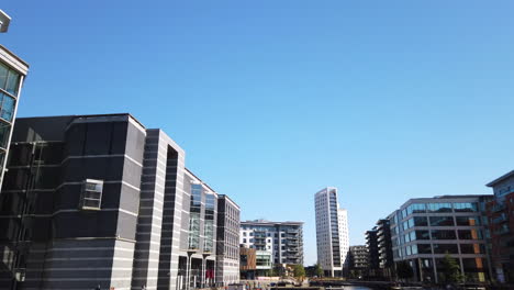 Tiro-Del-Desarrollo-Mixto-Del-Muelle-De-Leeds-En-Yorkshire,-Reino-Unido-En-Un-Día-Soleado-De-Verano-Desvaneciéndose-Diagonalmente-A-La-Izquierda-Hacia-El-Cielo-Azul-En-Cámara-Lenta