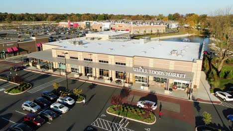 Wide-angle-aerial-view-of-Whole-Foods-Market,-busy-parking-lot-as-shoppers-purchase-healthy-fresh-grocery-food