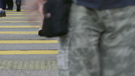 The-legs-of-pedestrians-using-a-road-crossing-during-morning-rush-hour-in-the-Central-district