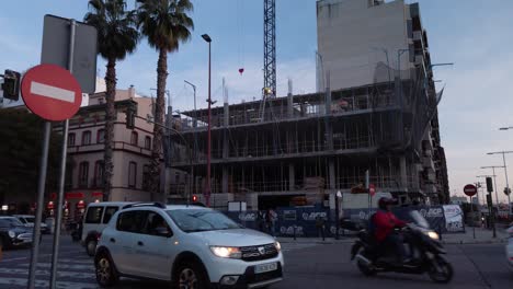 Grúa-En-El-Edificio-En-Construcción-Con-Inclinación-Hacia-Abajo-Revelando-El-Tráfico