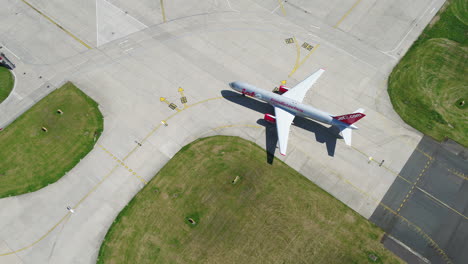 Aerial-footage-of-a-Jet2-aircraft-arriving-and-taxiing-onto-its-arrivals-gate