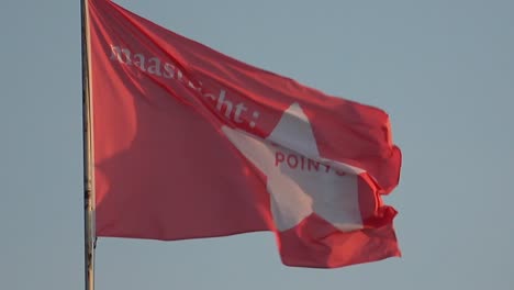 Slow-motion-shot-of-a-flag-waving-in-the-wind,-reading-Maastricht-douze-points