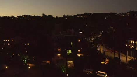 Beverly-Hills-Hotel-at-night,-California,-aerial-rising-reveal