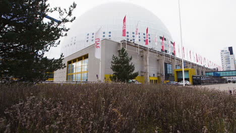 Low-pull-in-towards-Ericsson-Globe-with-flowers-in-the-foreground