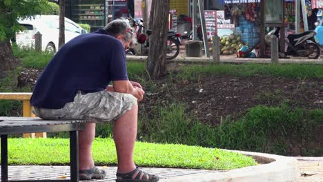 Wide-Shot-of-a-Man-on-Bench-by-the-River