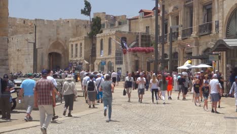 Tourists-and-locals-on-the-street-inside-the-city-walls-of-Jerusalem,-Palestine