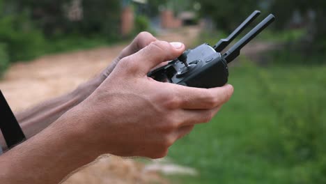 Medium-Close-Shot-of-Drone-Operator-Using-a-Drone-Controller