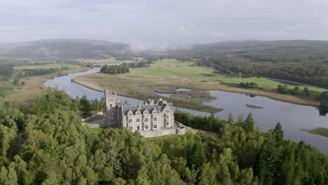 An-aerial-view-of-Carbisdale-Castle-on-a-sunny-morning-with-cloudy-skies