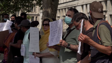 Undocumented-migrant-protestors-hold-placards-with-messages-demanding-their-human-rights,-to-be-made-legal,-to-be-given-the-right-to-work-and-ask-Prime-Minister-Boris-Johnson-to-keep-his-promise